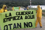Gulklädda aktivister står på en väg med banderoller: "No to a Nuclear Nato"